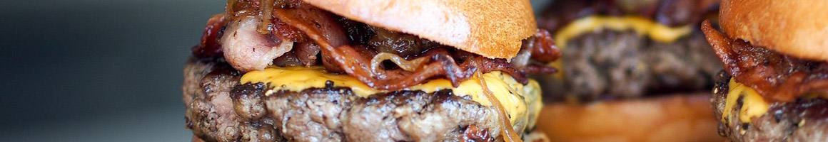 Eating Burger Fast Food at Hill-Bert's Burgers restaurant in Austin, TX.